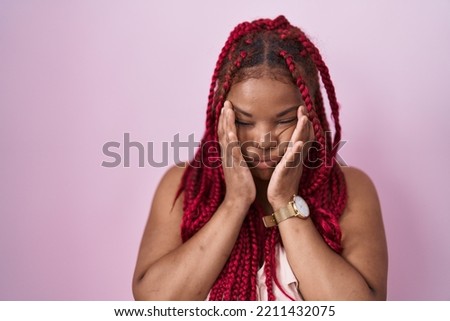 African american woman with braided hair standing over pink background rubbing eyes for fatigue and headache, sleepy and tired expression. vision problem 