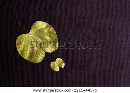 Indian festival dussehra , golden leaf with brown background Royalty-Free Stock Photo #2211444575