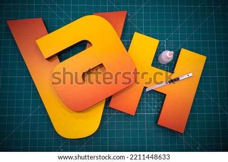 Production of outdoor advertising. Three-dimensional letters made of plastic for signage. Production of interior advertising in the shop. Glue the symbols from plastic.