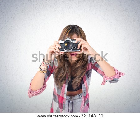 Pretty girl photographing over textured background 