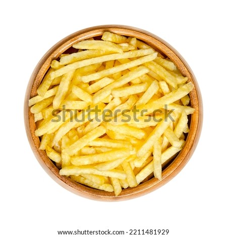 Salted potato sticks in a wooden bowl. Also called shoestring potatoes, a popular snack and variant of crispy potato chips. Extremely thin versions of French fries, deep fried in sunflower oil. Royalty-Free Stock Photo #2211481929