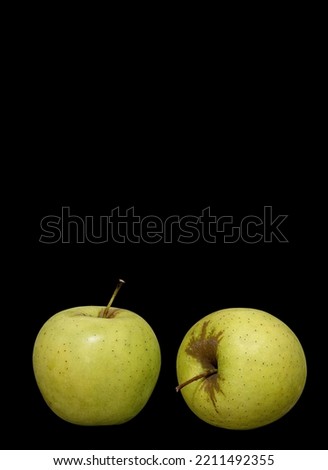 Image of two ripe green apples on a black background
