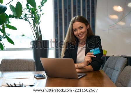 Joyous female office worker making online purchase
