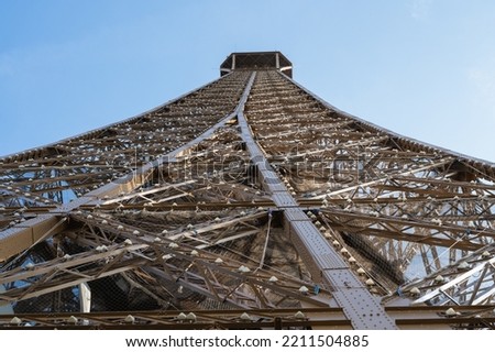 Eiffel tower close up. Angled view while climbing to the second froor of the landmark, selective focus