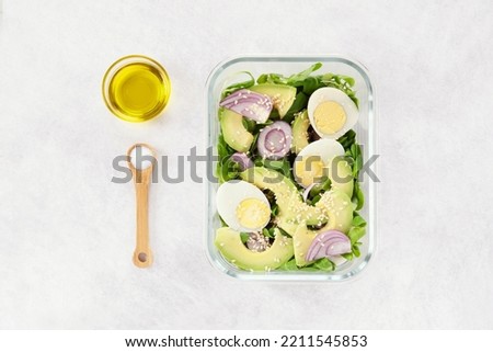 Batch cooking. Glass lunch box. Homemade meal preparation. Avocado salad with eggs. Organization of meals. Healthy and fresh cusine concept. Menu of the week. Starter, main course and dessert. Royalty-Free Stock Photo #2211545853