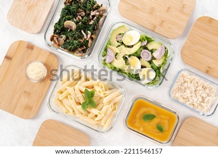 Batch cooking. Glass lunch boxes with bamboo lid. Meal preparation concept. Organization of meals. Healthy and fresh cuisine. Menu of the week. Starter, main course and dessert. Healthy nutrition. Royalty-Free Stock Photo #2211546157