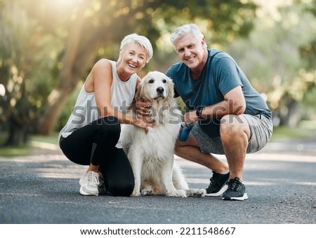 Happy senior couple, walking dog in nature park and smile bonding with their golden retriever together. Healthy living in retirement, being physically active by exercising and relaxing time with pet Royalty-Free Stock Photo #2211548667