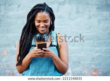 Black woman with 5g smartphone for social media typing, digital chat app or check location on blue wall background space mockup. Teenager gen z girl on cellphone for youth online website networking Royalty-Free Stock Photo #2211548835