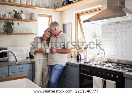 Love, kitchen and senior couple relax with cup of coffee, tea or hot drink while bonding and connect at home. Family, peace and elderly man and woman enjoy quality time, retirement and life together Royalty-Free Stock Photo #2211548977