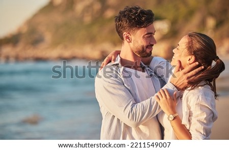 Love, beach and couple embrace at sunset for romantic summer evening date together in nature. Happy, sweet and satisfied people in relationship make eye contact for affection and care. Royalty-Free Stock Photo #2211549007