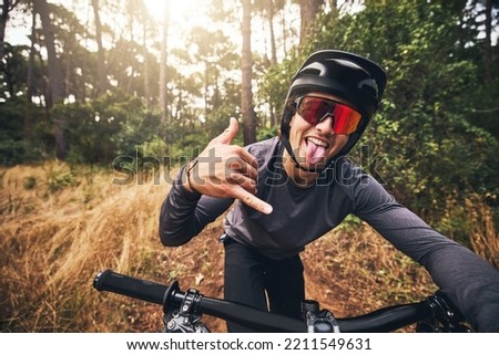 Mountain bike, cycling and fitness with a man gesture a shaka hand sign while training or exercise in Brazil nature. Portrait of a professional male sports athlete doing cardio ednurance in a forest