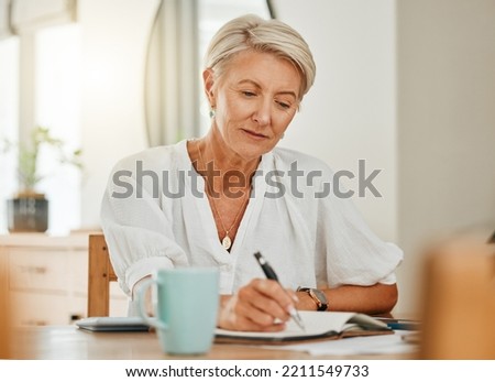 Writing, thinking and senior woman at a house making notes on notebook paper. Retirement of a serious person from Sweden think about schedule, day agenda idea or document and write ideas at home Royalty-Free Stock Photo #2211549733