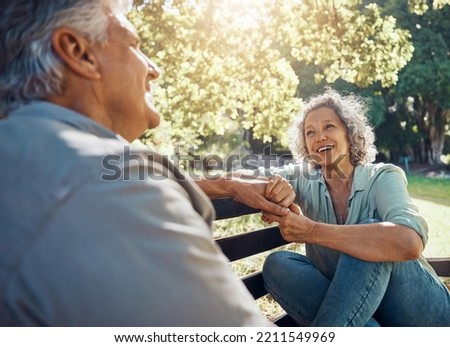 Elderly, couple and happy on bench in garden for conversation, bonding and happiness by trees in summer. Man, woman and retirement show love, relax and smile together in nature with sunshine at park Royalty-Free Stock Photo #2211549969