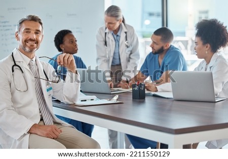 Portrait of doctor with team in a meeting in the office, having a strategy discussion. Business meeting, teamwork and leadership in healthcare, working online using computers in the medical industry