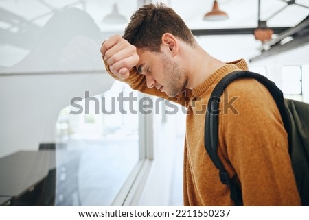 Burnout, depression or mental health with man student from anxiety or exam stress for education, college or university. Sad, headache or scared male thinking about fail, problem or project deadline Royalty-Free Stock Photo #2211550237