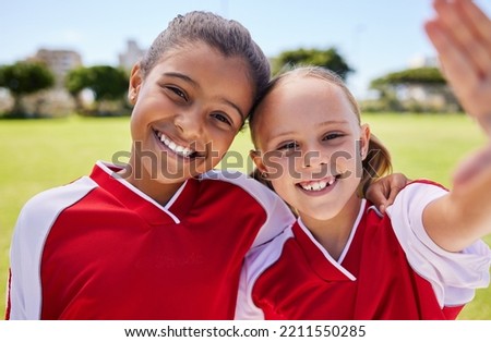 Selfie, soccer and sport with a girl team taking a photograph on a football field before a game with a smile. Children, sports and exercise with female child friends posing for a picture outside