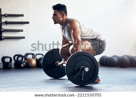 Workout, weightlifting and man doing deadlift training with strength, weights and motivation in fitness gym. Bodybuilder, sport and strong athlete doing power exercise with a dumbbell at health club Royalty-Free Stock Photo #2211550705