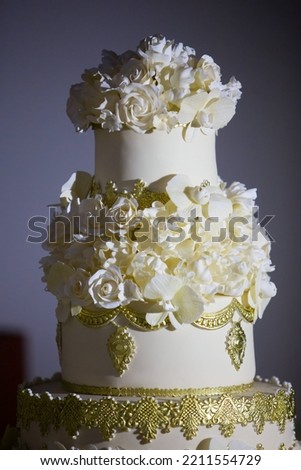 Elegant cake for a wedding celebration decorated with flowers made of caramel.