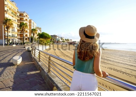 Tourism in Calabria. Back view of young woman on Crotone promenade on Calabria coast, Italy.