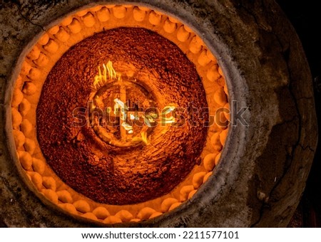 This facility is called tandir in Uzbek. It is also known in the Orient as a tandoor. This is an oven made of clay, and in it both bread and samsas are baked. Samsa is stuffed dumpling. Royalty-Free Stock Photo #2211577101