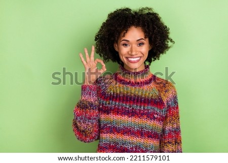 Photo of cool millennial valume hairdo lady show okey wear colorful pullover isolated on green color background
