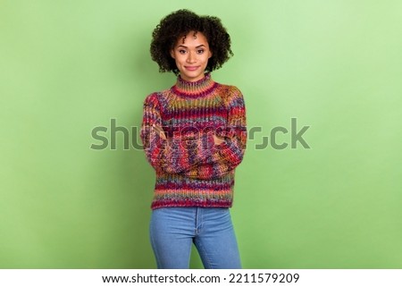 Portrait of pretty calm lady crossed arms look camera wear sweater isolated on green color background