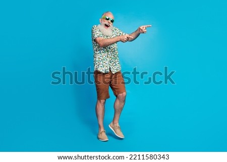 Full length photo of old excited crazy funny man boyfriend senior wear summer outfit fingers point empty space cool isolated on blue color background