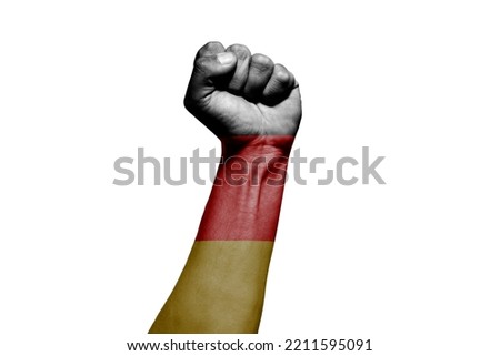 Strong man's hand in battle signal with Germany flag on white background.