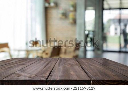 Empty wooden table space platform and blurred office or meeting room background for product display montage.