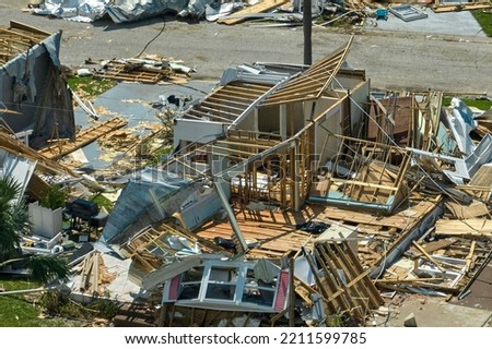 Destroyed by hurricane Ian suburban houses in Florida mobile home residential area. Consequences of natural disaster Royalty-Free Stock Photo #2211599785