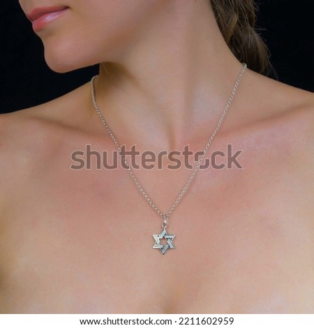 Attractive female silver chain with pendant hangs around neck of a young girl. Jewelry photo for e commerce, online sale, social media.