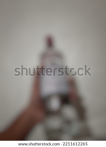 Defocused or blurred abstract background of a bottle of alcoholic beverage