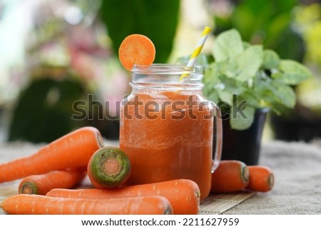 Fresh carrot juice served in glass on table. Carrot healthy juice for detox.