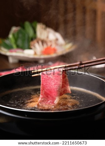 Japanese Wagyu A5 Shabu Shabu and Sukiyaki, vegetables set in the background, premium beef set, asian popular dish, japan local dish, chopsticks holding beef, fresh beef.  Royalty-Free Stock Photo #2211650673