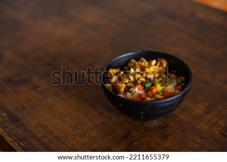 a portion of chicken cut into small pieces with rice plus delicious fresh vegetables.