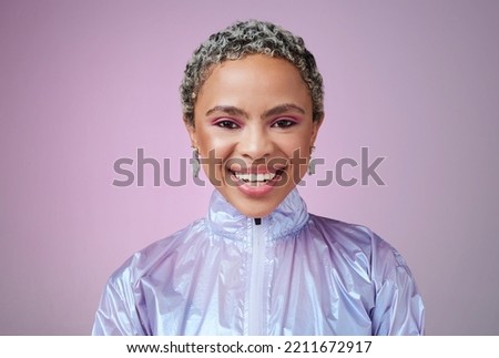 Black woman, fashion and smile with holographic purple studio background with a happy, cosmetics and makeup for retro style. Face beauty portrait of an African female looking trendy with vaporwave Royalty-Free Stock Photo #2211672917