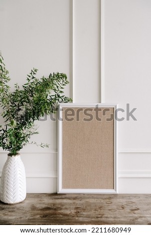 White square poster in concrete wall and wooden floor shelf, template mock up for your content. Interior mockup frame background, scandinavian style with a bouquet of flower beside