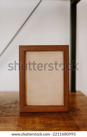 A gray frame on an old wooden table