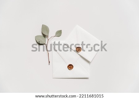 White envelope with a eucalyptus leaf