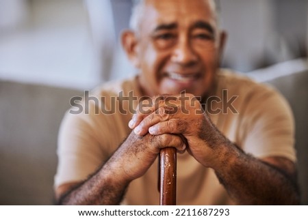 Portrait of a happy, kind black senior man hands with wrinkles, holding a walking stick and smiling in a retirement home sitting on outside relaxing and waiting in the queue