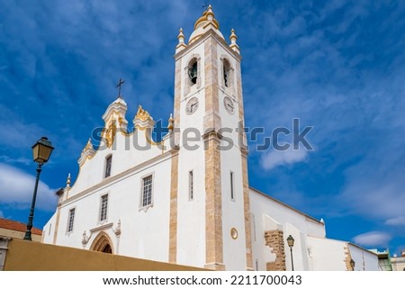 Low angle view of Baroque style white main church of the city Portimao in the Algarve area in Portugal called Igreja de nossa Senhora da Conceição (Church of Our Lady of the Conception) on a sunny day Royalty-Free Stock Photo #2211700043