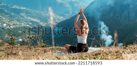 yoga in the mountains. Girl generation z practices in the mountains. Wellness, mental health, meditation, self care, physical health, physical fitness and outdoor sports. Royalty-Free Stock Photo #2211718593