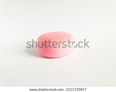 pink fake macaron made of plastic isolated on white background.
