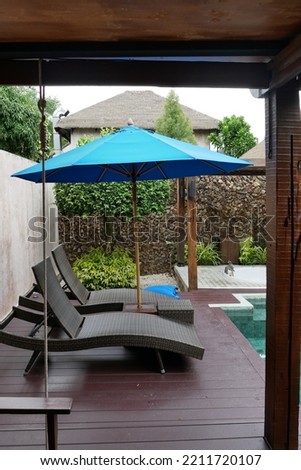 Beautiful umbrella and chair around swimming pool in hotel and resort - vacation concept