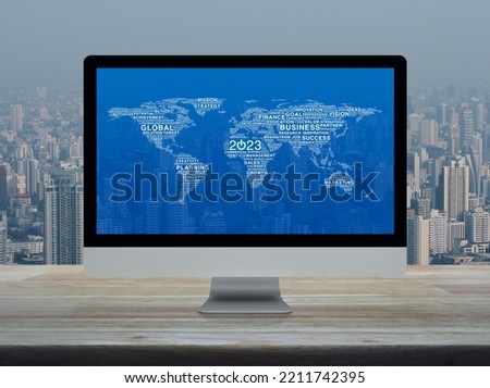 Start up business icon with global words world map on computer screen on wooden table over office building city tower, Happy new year 2023 start up online, Elements of this image furnished by NASA