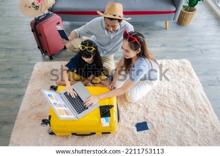 Young happy family asian father mother and daughter happy exciting preparing luggage suitcase booking ticket and hotel for vacation holiday travel trip