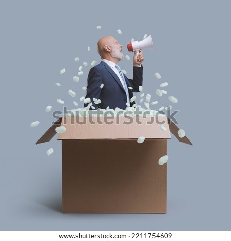 Businessman shouting with a megaphone in a delivery box, business and marketing concept