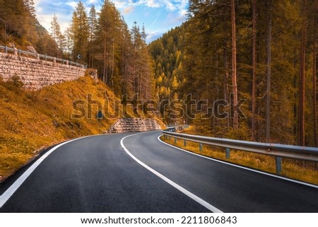 Beautiful autumn landscape with roadway. Highway in mountains in fall day in Italy, empty asphalt road. Dolomites, Alps 
