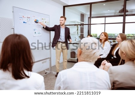 group of business men and women  are meeting together, giving opinions, discussing and exchanging ideas  by everyone cooperating and having good unity