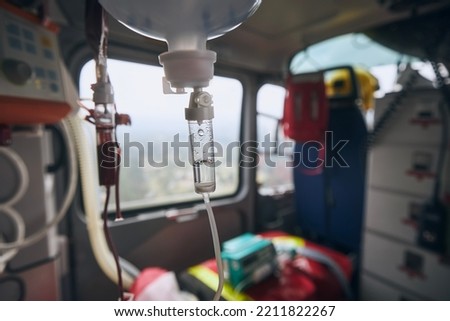 Selective focus on infusion on board helicoter of emergency medical service. Themes rescue, urgency and health care.

